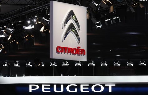 Peugeot and Citroen logos are seen over the French carmakers' showcases on media day at the Paris Mondial de l'Automobile, September 28, 201 Peugeot and Citroen logos are seen over the French carmakers' showcases on media day at the Paris Mondial de l'Automobile, September 28, 201