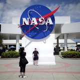 Tourists take pictures of a NASA sign at the Kennedy Space Center visitors complex in Cape Canaveral, Florida April 14, 2010. REUTERS/Carlos Tourists take pictures of a NASA sign at the Kennedy Space Center visitors complex in Cape Canaveral, Florida April 14, 2010. REUTERS/Carlos
