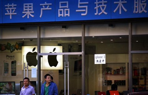 Customers walk out of a store selling and advertising Apple products, including both the iPhone 4 and iPhone 5, in central Beijing September Customers walk out of a store selling and advertising Apple products, including both the iPhone 4 and iPhone 5, in central Beijing September