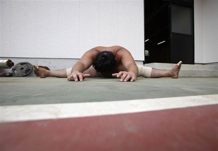 A sumo wrestler stretches during a summer camp at a freshly rebuilt stable in Soma, in Fukushima prefecture, northern Japan August 6, 2011. A sumo wrestler stretches during a summer camp at a freshly rebuilt stable in Soma, in Fukushima prefecture, northern Japan August 6, 2011.
