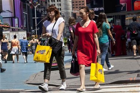 Women carry shopping bags through Times Square in New York, July 27, 2012. REUTERS/Andrew Burton Women carry shopping bags through Times Square in New York, July 27, 2012. REUTERS/Andrew Burton
