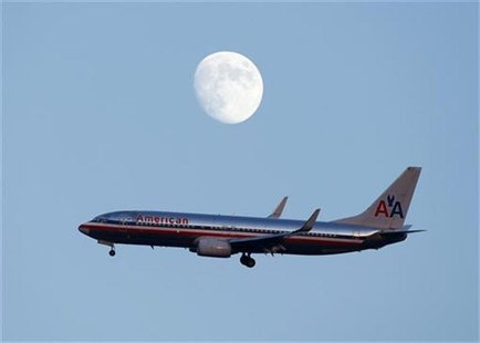 An American Airlines passenger jet glides in under the moon as it lands at LaGuardia airport in New YorkNew York, August 28, 2012. REUTERS/E An American Airlines passenger jet glides in under the moon as it lands at LaGuardia airport in New YorkNew York, August 28, 2012. REUTERS/E