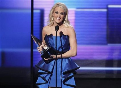 Carrie Underwood accepts the award for favorite country album for "Blown Away" at the 40th American Music Awards in Los Angeles, California, Carrie Underwood accepts the award for favorite country album for "Blown Away" at the 40th American Music Awards in Los Angeles, California,