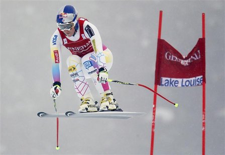U.S. skier Lindsey Vonn speeds past a gate in the fog during the first Women's World Cup Downhill skiing race of the season in Lake Louise, U.S. skier Lindsey Vonn speeds past a gate in the fog during the first Women's World Cup Downhill skiing race of the season in Lake Louise,