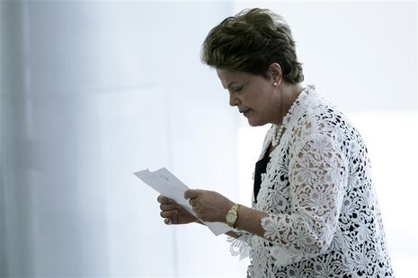 Brazil's President Dilma Rousseff reads a piece of paper at an event for the announcement of measures to expand the Affectionate Brazil Prog Brazil's President Dilma Rousseff reads a piece of paper at an event for the announcement of measures to expand the Affectionate Brazil Prog