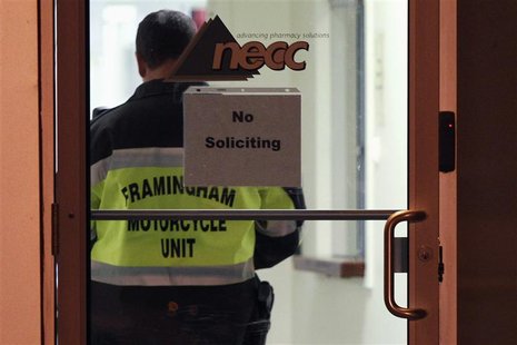 A Framingham Motorcycle Unit officer stands by while federal agents search New England Compounding Center in Framingham, Massachusetts Octob A Framingham Motorcycle Unit officer stands by while federal agents search New England Compounding Center in Framingham, Massachusetts Octob