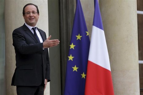 French President Francois Hollande jokes with journalists before welcoming European Central Bank (ECB) President Mario Draghi at the Elysee French President Francois Hollande jokes with journalists before welcoming European Central Bank (ECB) President Mario Draghi at the Elysee