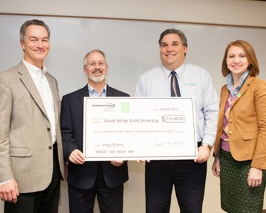 Officials of Grand Valley State University accept a $116,280 check from Consumers Energy on Nov. 30, 2012, as part of the utility's Energy Efficiency Program. From left: Tim Thimmesch, GVSU Facilities Services; GVSU Terry Pahl, Facilities Services; Todd Duncan, Consumers Energy; Lauren Youngdahl, Consumers Energy (photo courtesy GVSU) Officials of Grand Valley State University accept a $116,280 check from Consumers Energy on Nov. 30, 2012, as part of the utility's Energy Efficiency Program. From left: Tim Thimmesch, GVSU Facilities Services; GVSU Terry Pahl, Facilities Services; Todd Duncan, Consumers Energy; Lauren Youngdahl, Consumers Energy (photo courtesy GVSU)