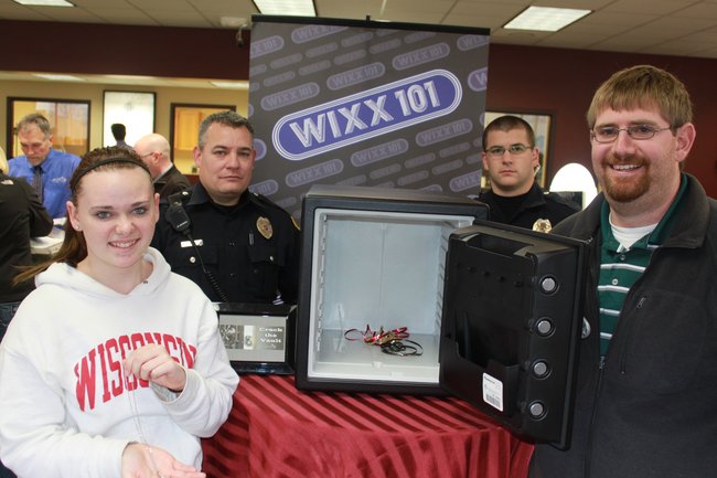 The winner! Lori Beyer of New Franken qualified on WIXX and sent her son (right) to the Crack the Code event (hey, she had to work). Their code opened the vault and we had our winner!