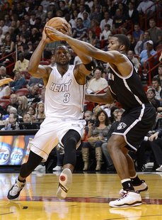 Miami Heat's Dwyane Wade (L) is defended by Brooklyn Nets's Joe Johnson during the first half of their NBA basketball game in Miami, Florida Miami Heat's Dwyane Wade (L) is defended by Brooklyn Nets's Joe Johnson during the first half of their NBA basketball game in Miami, Florida