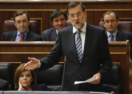 Spanish Prime Minister Mariano Rajoy (C) talks next to Spanish Deputy Prime Minister Soraya Saenz de Santamaria during a parliamentary sessi Spanish Prime Minister Mariano Rajoy (C) talks next to Spanish Deputy Prime Minister Soraya Saenz de Santamaria during a parliamentary sessi