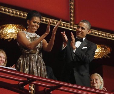 U.S. President Barack Obama (R) and first lady Michelle Obama applaud on the balcony as they attend the 2012 Kennedy Center Honors at the Ke U.S. President Barack Obama (R) and first lady Michelle Obama applaud on the balcony as they attend the 2012 Kennedy Center Honors at the Ke