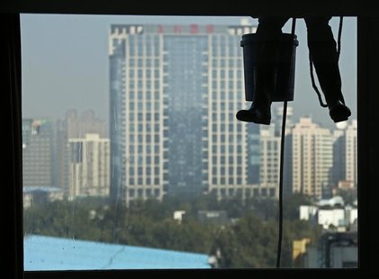 A worker cleans the window of an apartment building at a residential area in central Beijing, October 24, 2012. REUTERS/Petar Kujundzic A worker cleans the window of an apartment building at a residential area in central Beijing, October 24, 2012. REUTERS/Petar Kujundzic