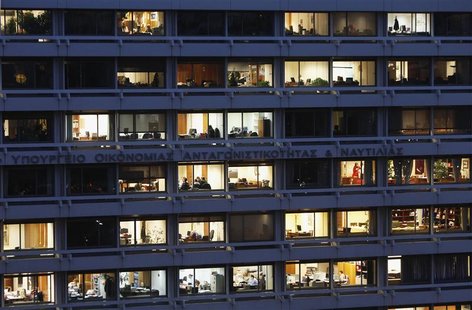 Employees are seen working in their offices in the building housing Greece's finance and development ministries in Athens November 29, 2012. Employees are seen working in their offices in the building housing Greece's finance and development ministries in Athens November 29, 2012.