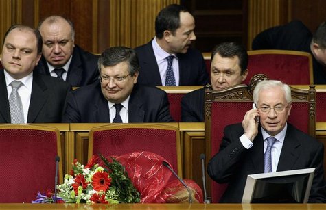 Then Ukrainian Prime Minister Mykola Azarov (R, front) talks on the phone after he was appointed as prime minister in Kiev in this March 11, Then Ukrainian Prime Minister Mykola Azarov (R, front) talks on the phone after he was appointed as prime minister in Kiev in this March 11,
