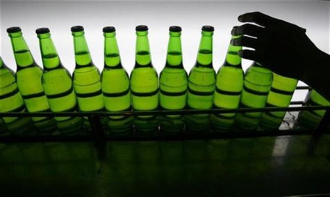 A man picks up a bottle at an assembly line inside the Taiwan Beer factory in Jhunan, Miaoli County February 13, 2008. REUTERS/Nicky Loh A man picks up a bottle at an assembly line inside the Taiwan Beer factory in Jhunan, Miaoli County February 13, 2008. REUTERS/Nicky Loh