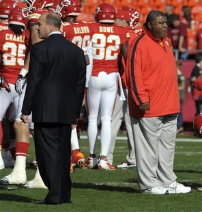 Kansas City Chiefs head coach Romeo Crennel (R) and general manager Scott Pioli watch their team before the start of their NFL football game Kansas City Chiefs head coach Romeo Crennel (R) and general manager Scott Pioli watch their team before the start of their NFL football game