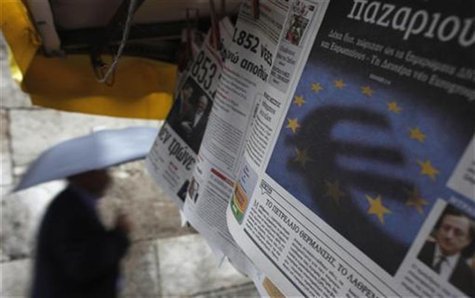A man passes by a newspaper featuring the Euro currency sign in central Athens November 21, 2012. REUTERS/John Kolesidis A man passes by a newspaper featuring the Euro currency sign in central Athens November 21, 2012. REUTERS/John Kolesidis