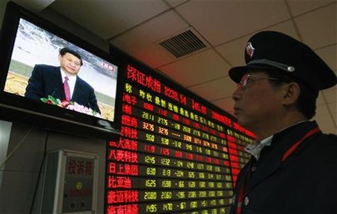 A security guard watches a screen showing newly-elected General Secretary of the Central Committee of the Communist Party of China (CPC) Xi A security guard watches a screen showing newly-elected General Secretary of the Central Committee of the Communist Party of China (CPC) Xi