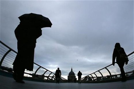 Commuters cross the Millennium Bridge during a rainy morning, towards the financial district the City of London November 27, 2012. REUTERS/S Commuters cross the Millennium Bridge during a rainy morning, towards the financial district the City of London November 27, 2012. REUTERS/S