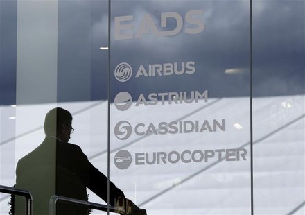 A visitor stands at the EADS booth during the ILA Berlin Air Show in Selchow near Schoenefeld south of Berlin, September 13, 2012. REUTERS/T A visitor stands at the EADS booth during the ILA Berlin Air Show in Selchow near Schoenefeld south of Berlin, September 13, 2012. REUTERS/T