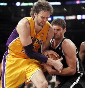 Los Angeles Lakers' Pau Gasol (L) of Spain fights for the ball with Brooklyn Nets' Brook Lopez during the second half of their NBA basketbal Los Angeles Lakers' Pau Gasol (L) of Spain fights for the ball with Brooklyn Nets' Brook Lopez during the second half of their NBA basketbal