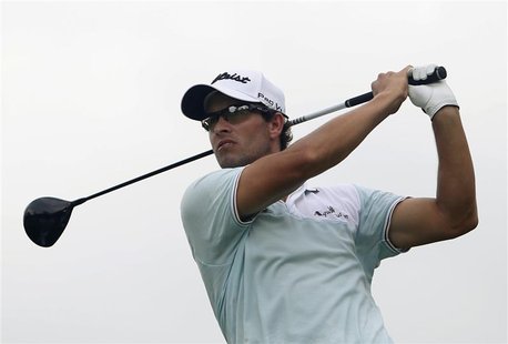 Adam Scott of Australia tees off on the ninth hole during the rain-delayed second round of the Barclays Singapore Open golf tournament in Se Adam Scott of Australia tees off on the ninth hole during the rain-delayed second round of the Barclays Singapore Open golf tournament in Se