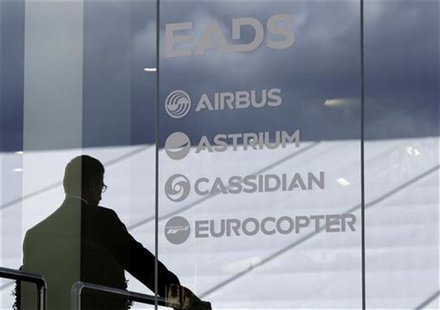 A visitor stands at the EADS booth during the ILA Berlin Air Show in Selchow near Schoenefeld south of Berlin, September 13, 2012. REUTERS/T A visitor stands at the EADS booth during the ILA Berlin Air Show in Selchow near Schoenefeld south of Berlin, September 13, 2012. REUTERS/T