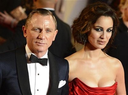 Actor Daniel Craig and actress Berenice Marlohe pose for photographers as they arrive for the royal world premiere of the new 007 film "Skyf Actor Daniel Craig and actress Berenice Marlohe pose for photographers as they arrive for the royal world premiere of the new 007 film "Skyf