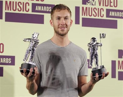DJ Calvin Harris poses backstage with statuettes after winning the award for "Best Electronic Dance Music Video " at the 2012 MTV Video Musi DJ Calvin Harris poses backstage with statuettes after winning the award for "Best Electronic Dance Music Video " at the 2012 MTV Video Musi