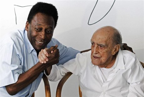 Brazilian soccer legend Pele (L) holds the hand of architect Oscar Niemeyer during a news conference in which they presented the plans for t Brazilian soccer legend Pele (L) holds the hand of architect Oscar Niemeyer during a news conference in which they presented the plans for t