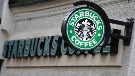 Coffee Shop Music Radio on Sign Is Seen Outside A Starbucks Coffee Shop In Central London