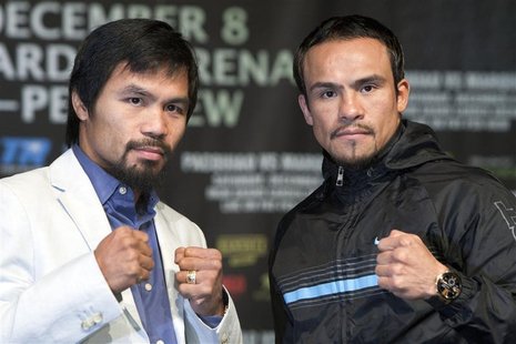 Filipino boxer Manny Pacquiao (L) and Juan Manuel Marquez of Mexico pose during a news conference at the MGM Grand in Las Vegas, Nevada Dece Filipino boxer Manny Pacquiao (L) and Juan Manuel Marquez of Mexico pose during a news conference at the MGM Grand in Las Vegas, Nevada Dece