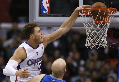 Los Angeles Clippers Blake Griffin (L) slam dunks over Dallas Mavericks Chris Kaman during their NBA basketball game in Los Angeles, Califor Los Angeles Clippers Blake Griffin (L) slam dunks over Dallas Mavericks Chris Kaman during their NBA basketball game in Los Angeles, Califor