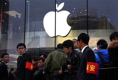 Security staff watch over a crowd gathered for the opening of a new Apple store in Beijing's Wangfujing shopping district October 20, 2012. Security staff watch over a crowd gathered for the opening of a new Apple store in Beijing's Wangfujing shopping district October 20, 2012.