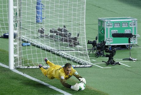 Goal keeper Tamati Williams of New Zealand's Auckland City catches the ball as a unit (green case) of a goal-line technology system by the F Goal keeper Tamati Williams of New Zealand's Auckland City catches the ball as a unit (green case) of a goal-line technology system by the F