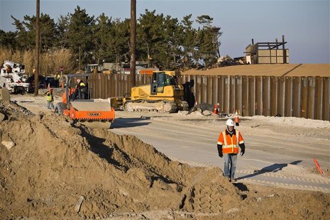 Construction workers repair roads destroyed by Hurricane Sandy, one month after the storm made landfall, in Mantoloking, New Jersey, Novembe Construction workers repair roads destroyed by Hurricane Sandy, one month after the storm made landfall, in Mantoloking, New Jersey, Novembe