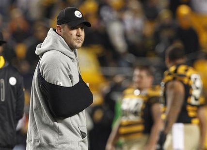 Injured Pittsburgh Steelers quarterback Ben Roethlisberger stands on the field with his arm in a sling before the start of their NFL footbal Injured Pittsburgh Steelers quarterback Ben Roethlisberger stands on the field with his arm in a sling before the start of their NFL footbal