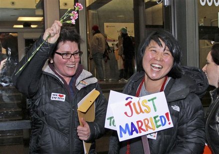 Junia Ribeiro (L), 51, and Patty Oh, 43, celebrate as they leave the King County Administration Building shortly after getting their marriag Junia Ribeiro (L), 51, and Patty Oh, 43, celebrate as they leave the King County Administration Building shortly after getting their marriag
