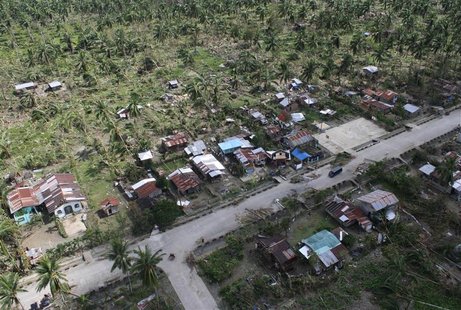 An aerial view of damaged houses caused by flash floods in Compostela Valley province, southern Philippines is seen in this handout photogra An aerial view of damaged houses caused by flash floods in Compostela Valley province, southern Philippines is seen in this handout photogra