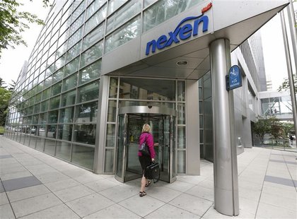 A woman walks into the Nexen building in downtown Calgary, Alberta, July 23, 2012. REUTERS/Todd Korol A woman walks into the Nexen building in downtown Calgary, Alberta, July 23, 2012. REUTERS/Todd Korol