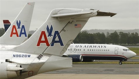 A US Airways plane passes American Airlines planes at Ronald Reagan National Airport in Washington April 23, 2012. REUTERS/Kevin Lamarque A US Airways plane passes American Airlines planes at Ronald Reagan National Airport in Washington April 23, 2012. REUTERS/Kevin Lamarque