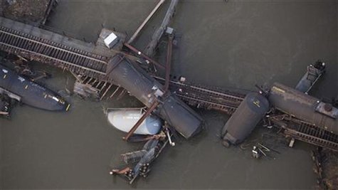 Derailed freight train cars sit semi-submerged in the waters of Mantua Creek after a train crash in Paulsboro, New Jersey November 30, 2012. Derailed freight train cars sit semi-submerged in the waters of Mantua Creek after a train crash in Paulsboro, New Jersey November 30, 2012.
