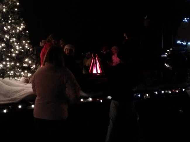 Singing Christmas Carols around the fire and floating through Mosinee during the Holiday Parade, Saturday, December 1, 2012.