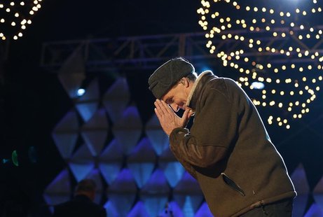 Singer James Taylor thanks the crowd after singing at the end of the show at the official lighting of the National Christmas Tree ceremony o Singer James Taylor thanks the crowd after singing at the end of the show at the official lighting of the National Christmas Tree ceremony o