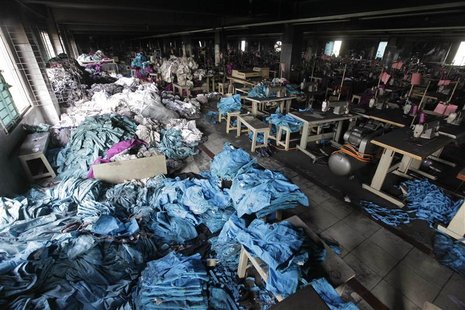 Piles of clothes are seen alongside sewing machines in the Tazreen Fashions garment factory, where 112 workers died in a devastating fire la Piles of clothes are seen alongside sewing machines in the Tazreen Fashions garment factory, where 112 workers died in a devastating fire la