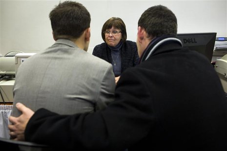 Candice Cathcart, (C) an administrative specialist with King County Elections assists Matt Beebe, (L) and David Mifflin as they filed for th Candice Cathcart, (C) an administrative specialist with King County Elections assists Matt Beebe, (L) and David Mifflin as they filed for th