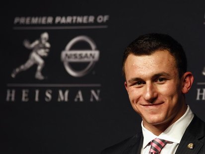 Texas A&M quarterback Johnny Manziel looks on during a news conference after winning the Heisman Trophy award in New York December 8, 2012. Texas A&M quarterback Johnny Manziel looks on during a news conference after winning the Heisman Trophy award in New York December 8, 2012.