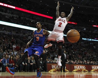 Chicago Bulls' Nate Robinson (R) loses the ball as he goes to the basket against New York Knicks' J.R. Smith during the second half of their Chicago Bulls' Nate Robinson (R) loses the ball as he goes to the basket against New York Knicks' J.R. Smith during the second half of their