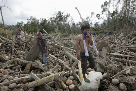Residents search for their missing relatives among debris swept by floodwaters at the height of Typhoon Bopha, in New Bataan town in Compost Residents search for their missing relatives among debris swept by floodwaters at the height of Typhoon Bopha, in New Bataan town in Compost
